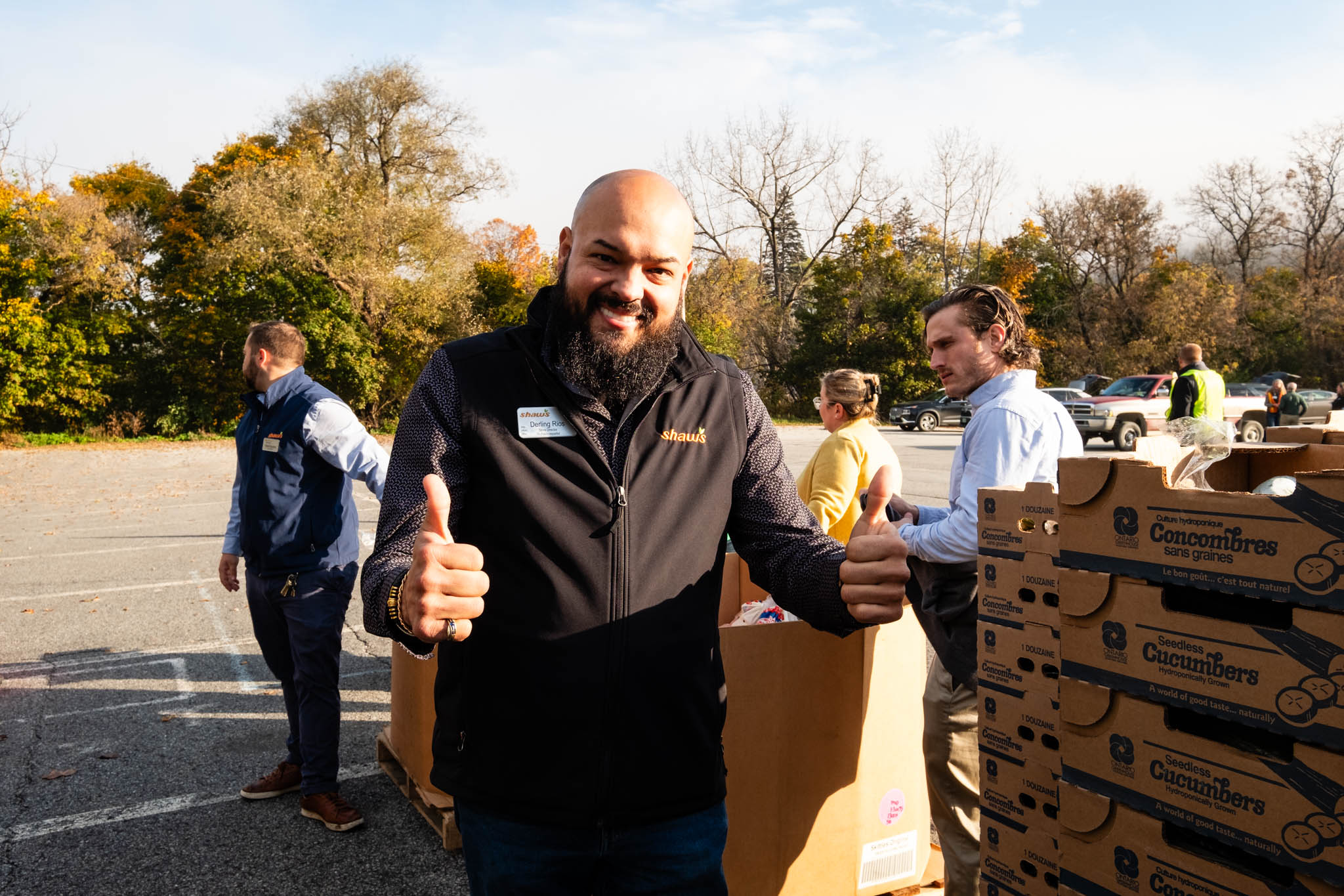 Photo of Shaw's employee giving the thumbs up at a food distribution event.
