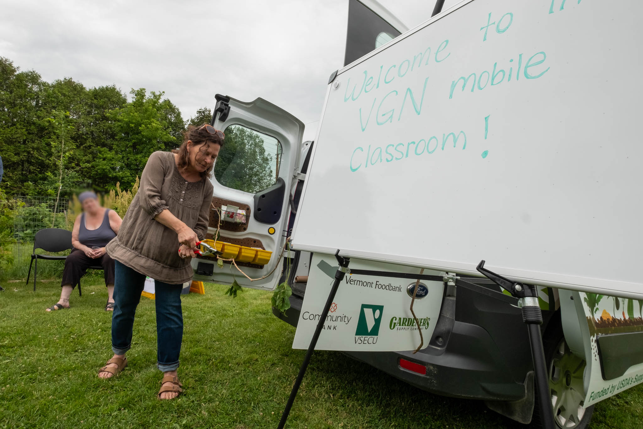 Photo of a woman cutting the ribbon for the new VGN Mobile Classroom.